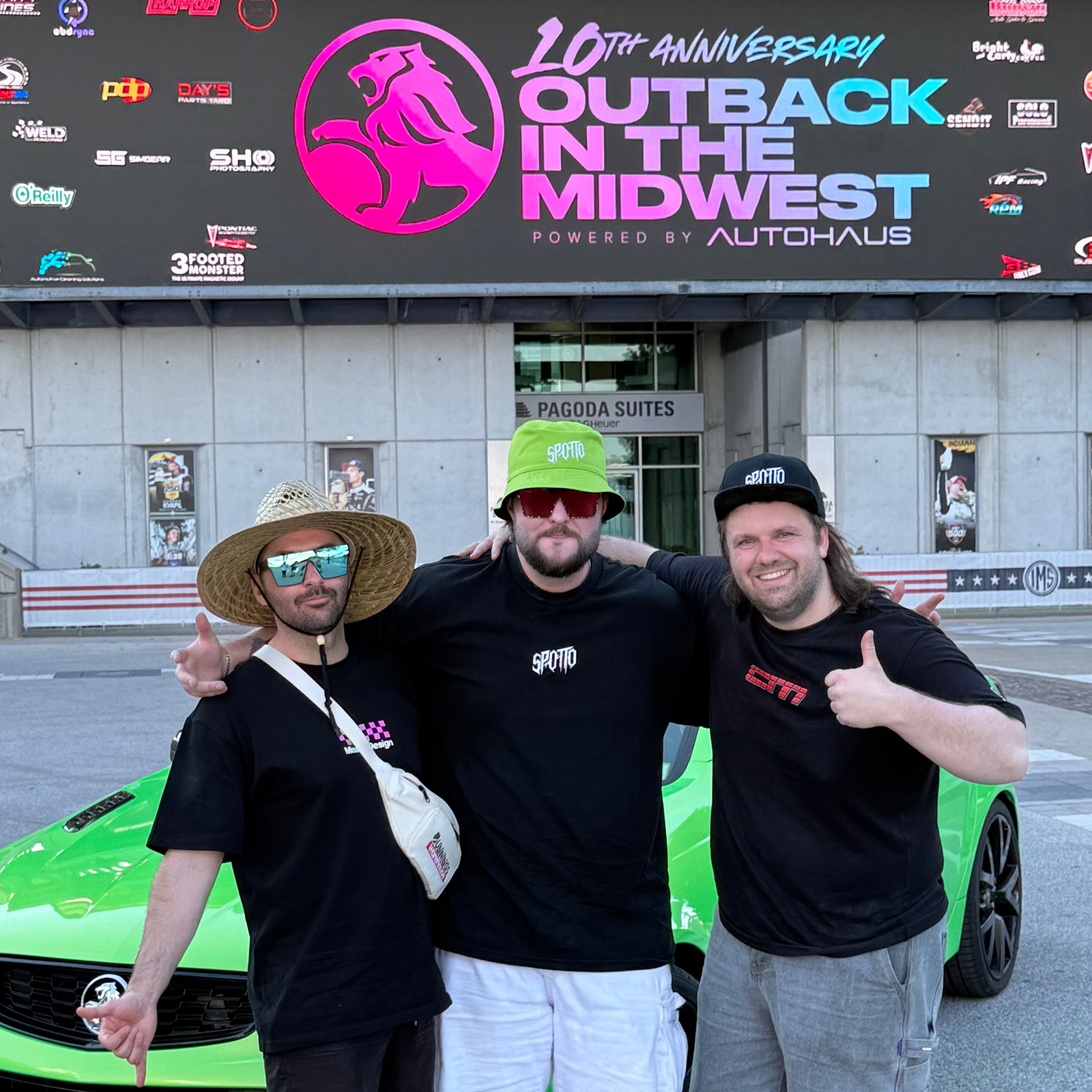 The Spotto crew in front of the green car at Outback in the Midwest.